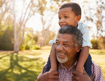 Dementia treatment patient holds grandson in the park