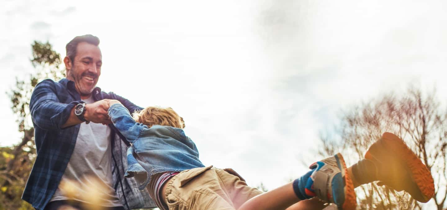 Functional medicine patient outside playing with young son