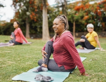 Functional medicine patients doing yoga in the park