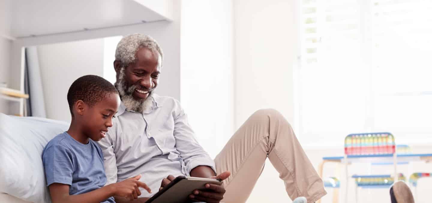 Integrative cardiology and functional medicine patient reads with grandson